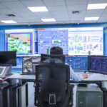 Operator in a modern control room managing technological systems in El Agustino, Lima.